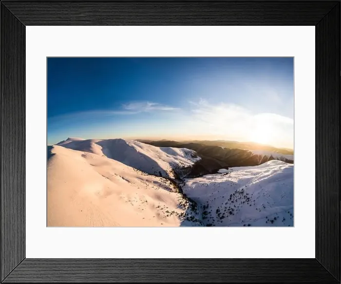 Framed Print : Top view of an unforgettable ski slope covered with snow located in the mountains in the northern country on a sunny Framed Print : Top view of an unforgettable ski slope covered with snow located in the mountains in the northern country on a sunny