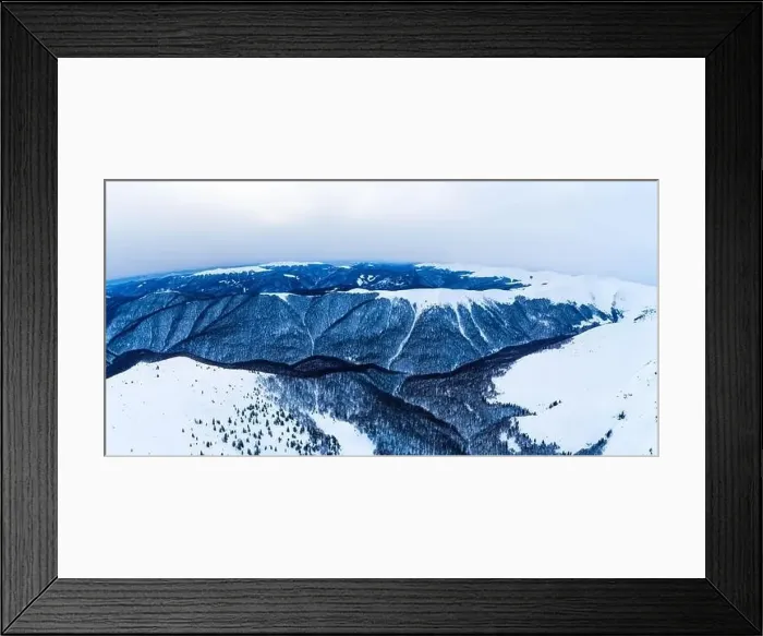 Framed Print : Stunning view of the cliffs covered with snow and trees on a cloudy winter day at the ski resort Framed Print : Stunning view of the cliffs covered with snow and trees on a cloudy winter day at the ski resort