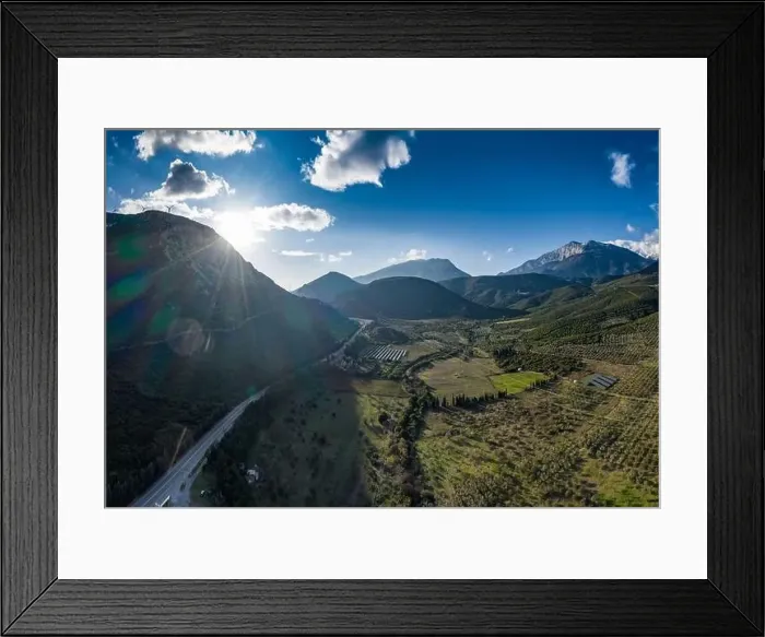 Framed Print : Aerial panorama of valley, morning fog over mountains, Twisting road, Tops and slopes of mountains Framed Print : Aerial panorama of valley, morning fog over mountains, Twisting road, Tops and slopes of mountains
