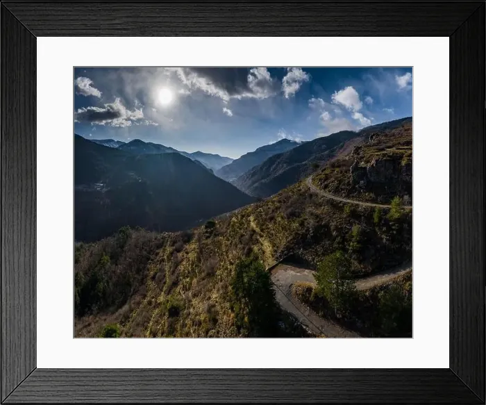 Framed Print : Aerial panoramic drone view of a scenic highway by the beautiful Landscape covered in clouds and fog Framed Print : Aerial panoramic drone view of a scenic highway by the beautiful Landscape covered in clouds and fog