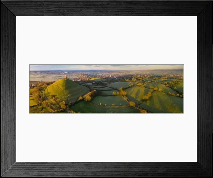 Framed Print : Aerial view by drone of Glastonbury Tor on a frosty morning on the Somerset Levels Framed Print : Aerial view by drone of Glastonbury Tor on a frosty morning on the Somerset Levels