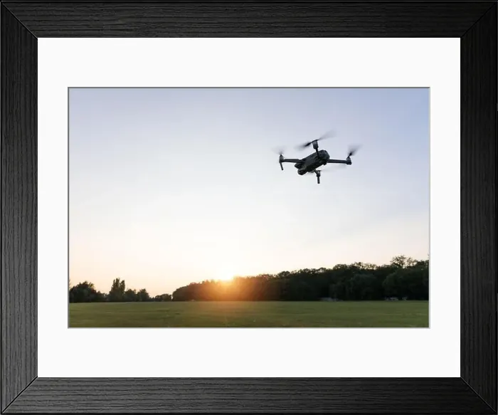 Framed Print : Drone flying over landscape. UAV drone copter flying with digital camera Framed Print : Drone flying over landscape. UAV drone copter flying with digital camera