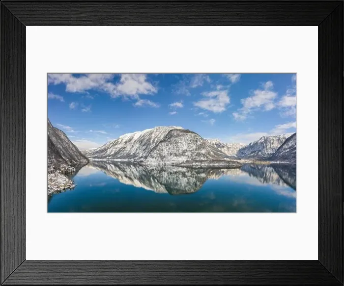 Framed Print : Aerial drone shot of snow covered hill with reflection by Hallstatt lake in Austria during winter time Framed Print : Aerial drone shot of snow covered hill with reflection by Hallstatt lake in Austria during winter time