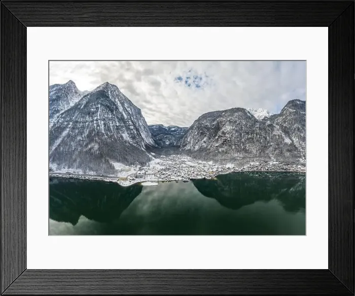 Framed Print : Aerial drone shot of Lahn village covered by snow by Hallstatt lake in Austria during winter Framed Print : Aerial drone shot of Lahn village covered by snow by Hallstatt lake in Austria during winter