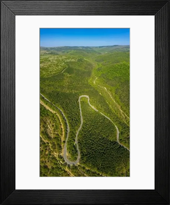 Framed Print : Aerial view from drone to the road through mountain Framed Print : Aerial view from drone to the road through mountain