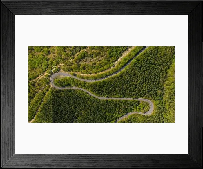 Framed Print : Aerial view from drone to the road through mountain Framed Print : Aerial view from drone to the road through mountain