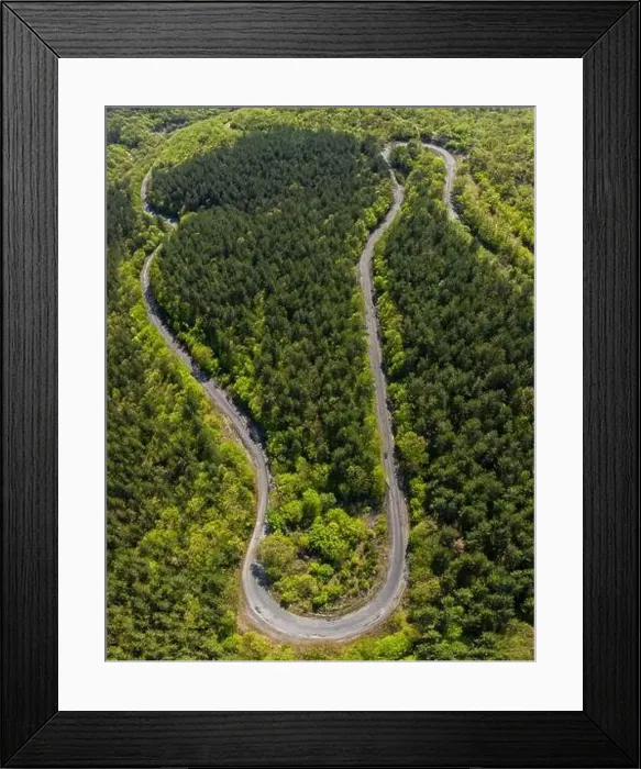 Framed Print : Aerial view from drone to the road through mountain Framed Print : Aerial view from drone to the road through mountain
