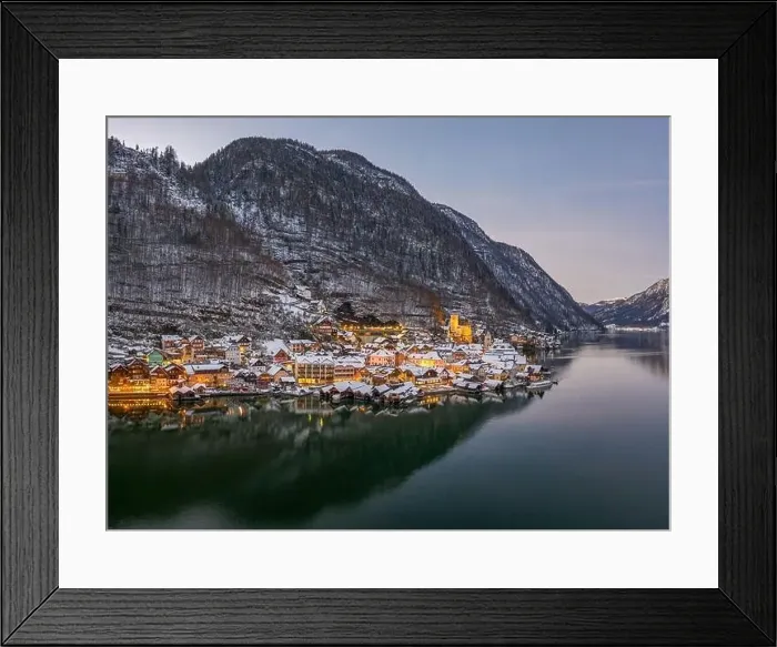 Framed Print : Aerial drone shot of Hallstatt village covered by snow during du Framed Print : Aerial drone shot of Hallstatt village covered by snow during du
