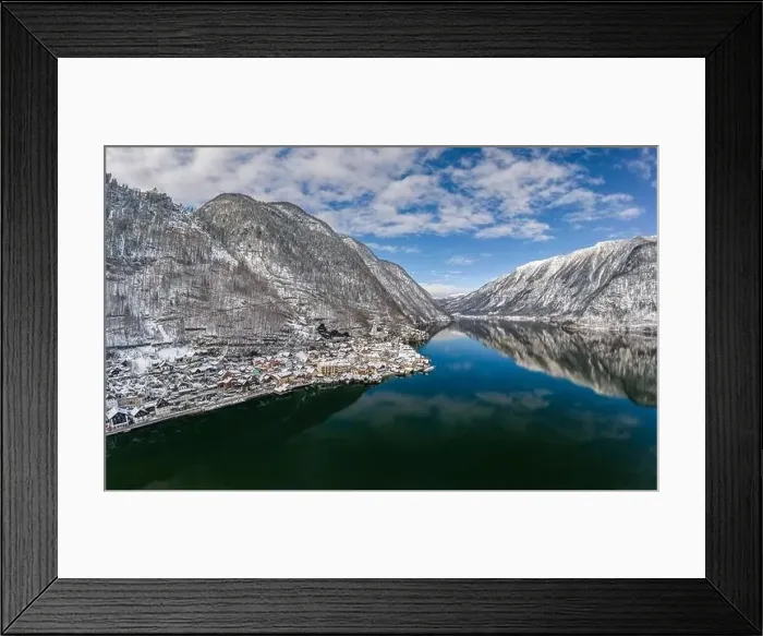 Framed Print : Aerial drone shot of Austrian snowy village by Hallstatt lake under blue sky in winter snowy time Framed Print : Aerial drone shot of Austrian snowy village by Hallstatt lake under blue sky in winter snowy time