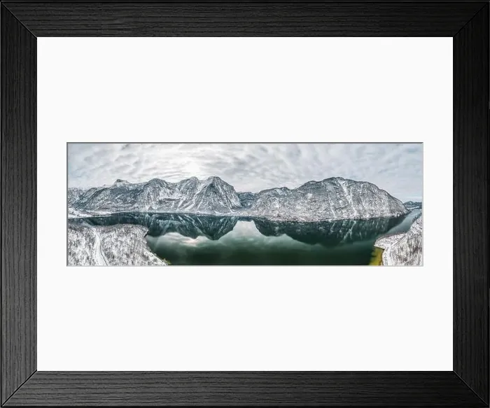 Framed Print : Aerial panoramic drone shot of Hallstatt village by lake surrounded by snow mountains with couds during winter Framed Print : Aerial panoramic drone shot of Hallstatt village by lake surrounded by snow mountains with couds during winter