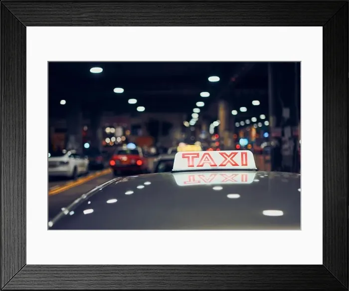 Framed Print : Lighting taxi sign on roof of car on city street at night, Hong Kong Framed Print : Lighting taxi sign on roof of car on city street at night, Hong Kong