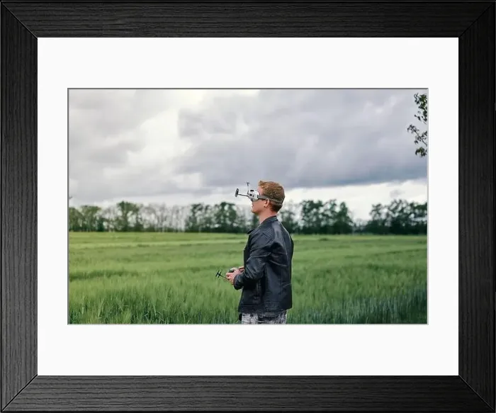 Framed Print : a man controls drone on the street Framed Print : a man controls drone on the street