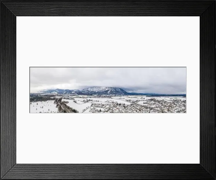 Framed Print : Panoramic aerial view of Austrian mountain half in fog with Anif snowy village in outskirt in the foreground in winter
