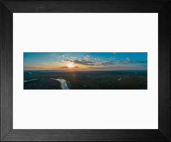 Framed Print : Panoramic aerial view of the nature landscape with green meadows and a river at sunset Framed Print : Panoramic aerial view of the nature landscape with green meadows and a river at sunset