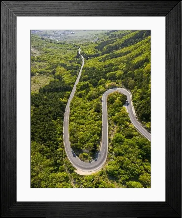 Framed Print : Aerial view of drone to road through mountain with bends Framed Print : Aerial view of drone to road through mountain with bends