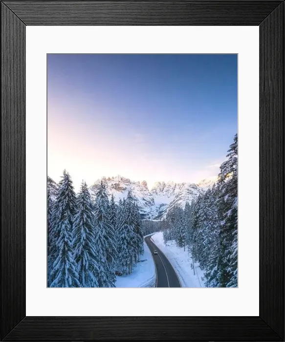 Framed Print : Aerial view by drone of car traveling on the scenic road Dobbiaco-Misurina along snowy woods at dawn Framed Print : Aerial view by drone of car traveling on the scenic road Dobbiaco-Misurina along snowy woods at dawn