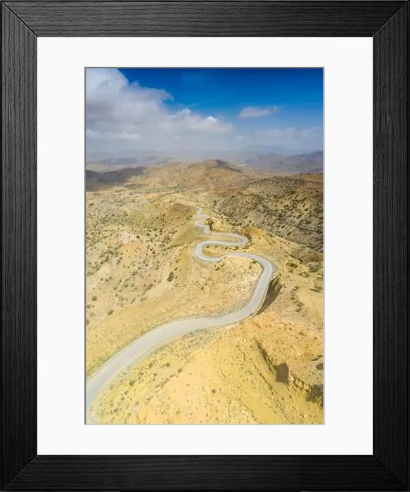 Framed Print : Panoramic view by drone of winding road towards Berhale crossing the dry landscape of Danakil desert Framed Print : Panoramic view by drone of winding road towards Berhale crossing the dry landscape of Danakil desert