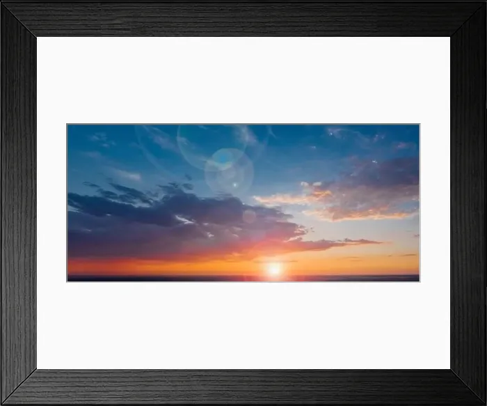Framed Print : Panorama of a beautiful sky with the sun and lens flare on the clouds against the backdrop of a calm summer evening Framed Print : Panorama of a beautiful sky with the sun and lens flare on the clouds against the backdrop of a calm summer evening