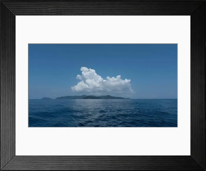 Framed Print : Small island in the middle of the sea with blue sky and white clouds above Framed Print : Small island in the middle of the sea with blue sky and white clouds above