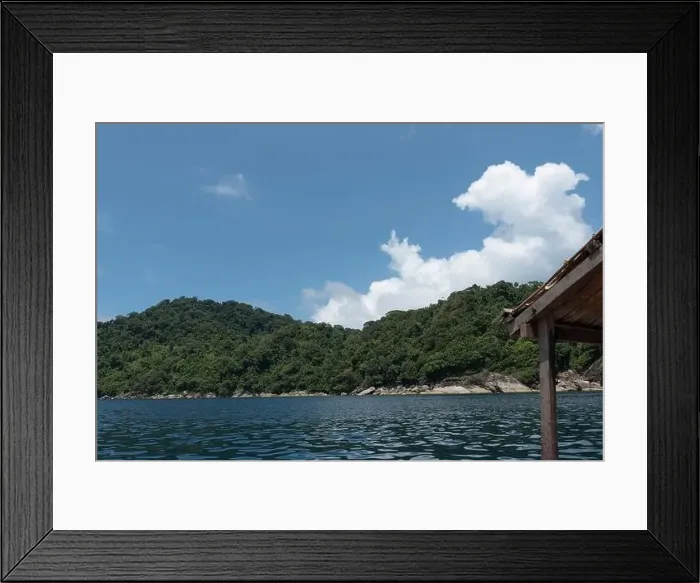 Framed Print : Small island in the middle of the sea with blue sky and white clouds above Framed Print : Small island in the middle of the sea with blue sky and white clouds above