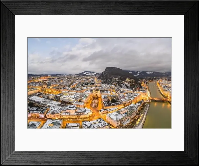 Framed Print : Aerial drone view of Holy Trinity Church in Salzburg covered with snow in winter at dusk with city lights on Framed Print : Aerial drone view of Holy Trinity Church in Salzburg covered with snow in winter at dusk with city lights on