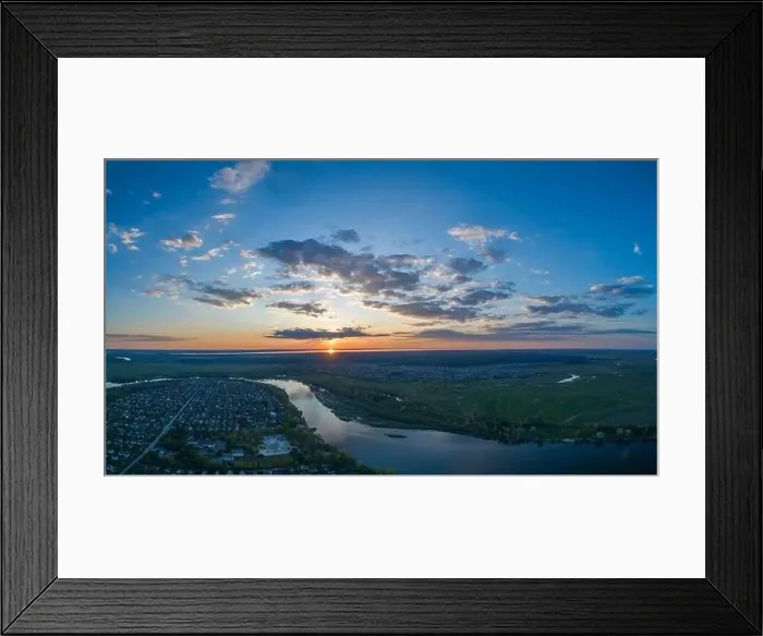 Framed Print : Panoramic aerial view of the nature landscape with green meadows and a river at sunset Framed Print : Panoramic aerial view of the nature landscape with green meadows and a river at sunset