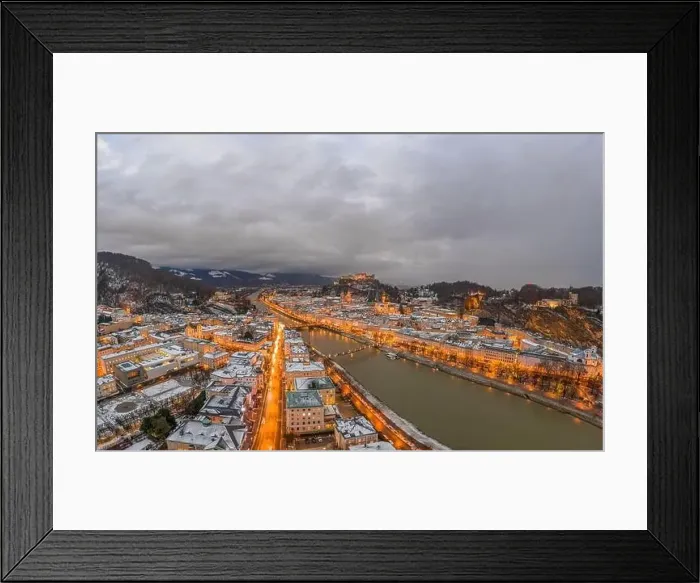 Framed Print : Panoramic aerial drone shot view of snowy Salzburg by river after sunset with heavy clouds after storm rain Framed Print : Panoramic aerial drone shot view of snowy Salzburg by river after sunset with heavy clouds after storm rain