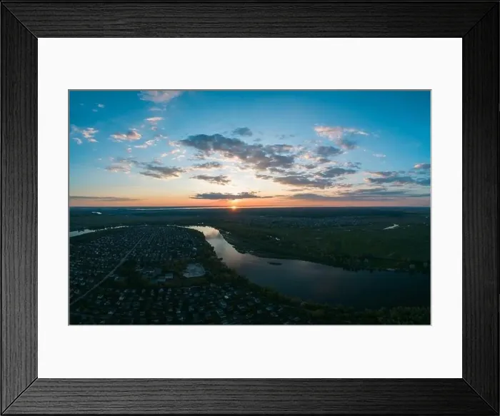 Framed Print : Stunning panoramic aerial view of the natural landscape with lush green meadows, a river and a village at sunset Framed Print : Stunning panoramic aerial view of the natural landscape with lush green meadows, a river and a village at sunset