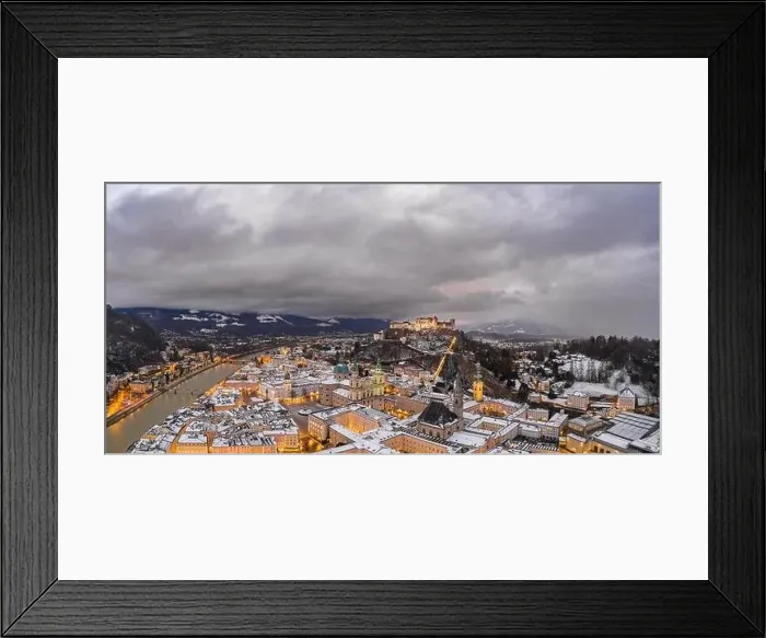 Framed Print : Panoramic aerial drone shot view of snowy Salzburg old town and Hohensalzb with city lights on during winter dusk hour Framed Print : Panoramic aerial drone shot view of snowy Salzburg old town and Hohensalzb with city lights on during winter dusk hour