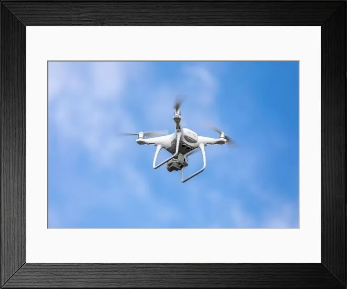 Framed Print : Drone quadrocopter with high resolution digital camera on the sky background Framed Print : Drone quadrocopter with high resolution digital camera on the sky background