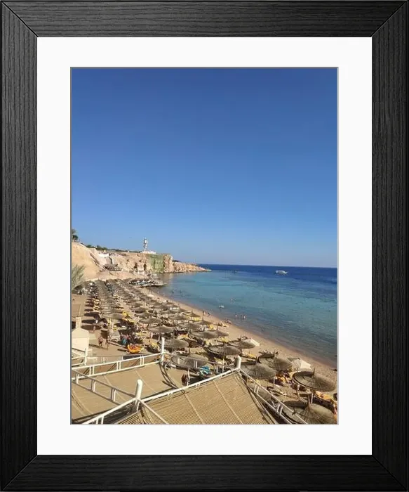 Framed Print : beach with umbrellas on sea with blue water