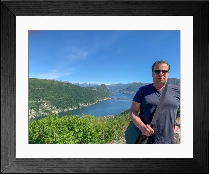Framed Print : Man and Panoramic View over Lugano with Alpine Lake and Mountain in a Sunny Day in Ticino, Switzerland Framed Print : Man and Panoramic View over Lugano with Alpine Lake and Mountain in a Sunny Day in Ticino, Switzerland