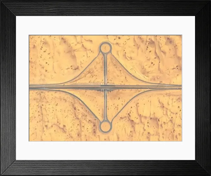 Framed Print : Aerial view of a road and roundabout crossing in the middle of a sandy desert in afternoon light Framed Print : Aerial view of a road and roundabout crossing in the middle of a sandy desert in afternoon light