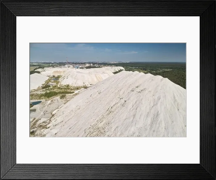 Framed Print : Mountain of plant waste on town background aerial drone view Framed Print : Mountain of plant waste on town background aerial drone view