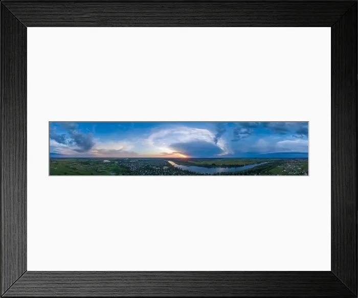 Framed Print : Panoramic aerial view of the nature landscape with green meadows and a river at sunset Framed Print : Panoramic aerial view of the nature landscape with green meadows and a river at sunset