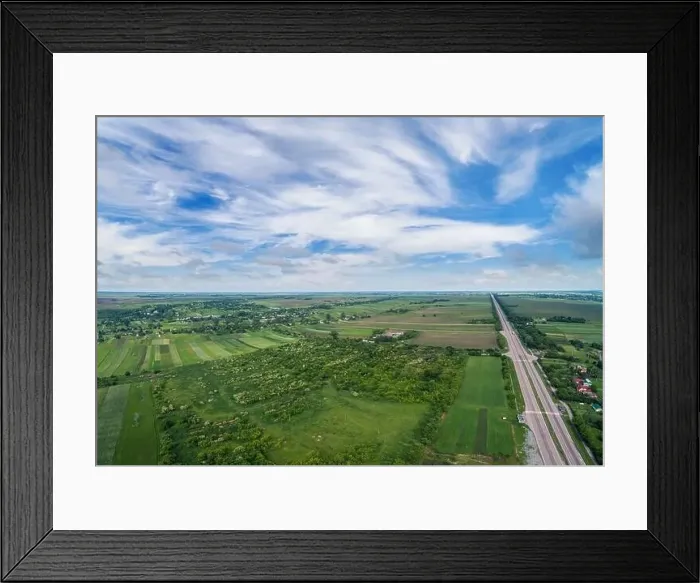 Framed Print : Summer rural landscape, aerial view. View of green fields, forest, village and highway Framed Print : Summer rural landscape, aerial view. View of green fields, forest, village and highway