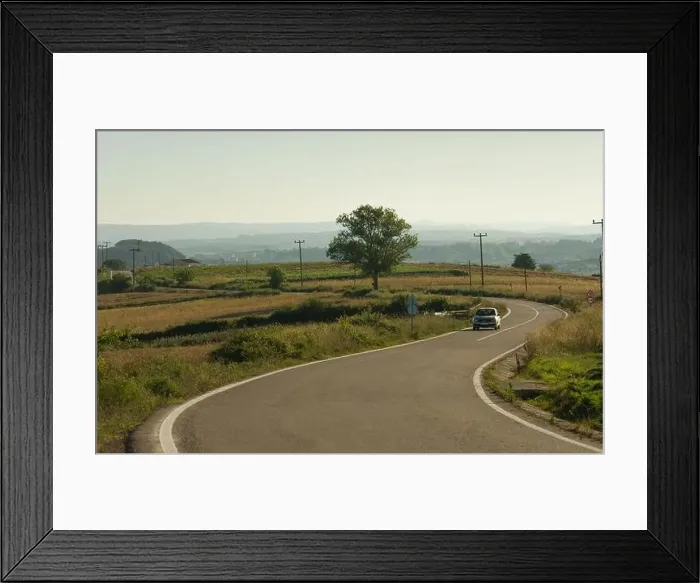 Framed Print : Transportation background. Car going on curvy village road Framed Print : Transportation background. Car going on curvy village road