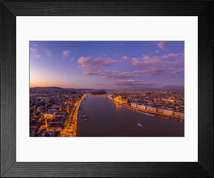 Framed Print : Aerial drone shot of Danube river with lighted quai with purple sky during Budapest sunset Framed Print : Aerial drone shot of Danube river with lighted quai with purple sky during Budapest sunset