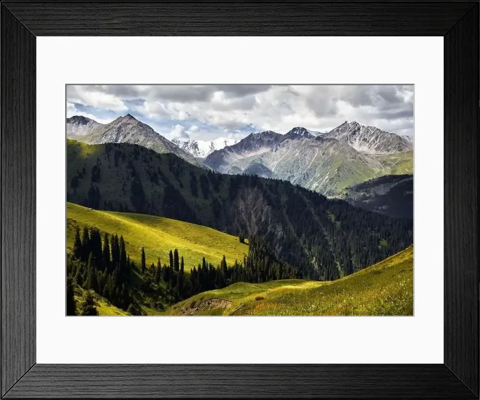 Framed Print : Aerial view of the mountain valley with lush forest and snowy peak in Kazakhstan Framed Print : Aerial view of the mountain valley with lush forest and snowy peak in Kazakhstan