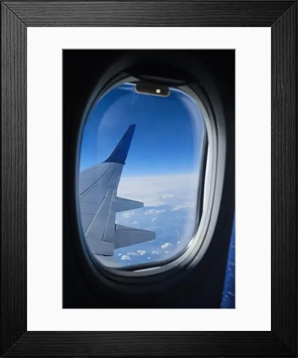 Framed Print : Airplane window view on the clouds and blue sky horizon. Plane wing vertical view in porthole Framed Print : Airplane window view on the clouds and blue sky horizon. Plane wing vertical view in porthole