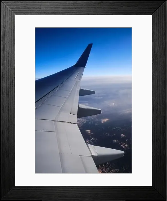 Framed Print : Airplane wing above mountains at sunset vertical view Framed Print : Airplane wing above mountains at sunset vertical view