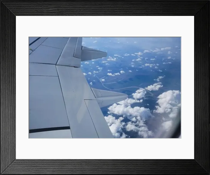 Framed Print : Porthole aerial view of the river landscape. Map view with clouds and river from airplane window Framed Print : Porthole aerial view of the river landscape. Map view with clouds and river from airplane window