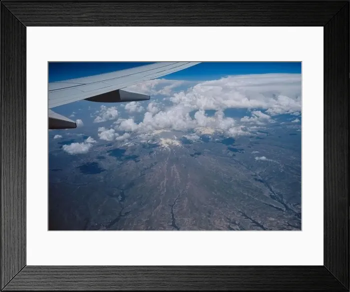 Framed Print : Aerial view from airplane window of clouds and mountain landscape Middle East Framed Print : Aerial view from airplane window of clouds and mountain landscape Middle East