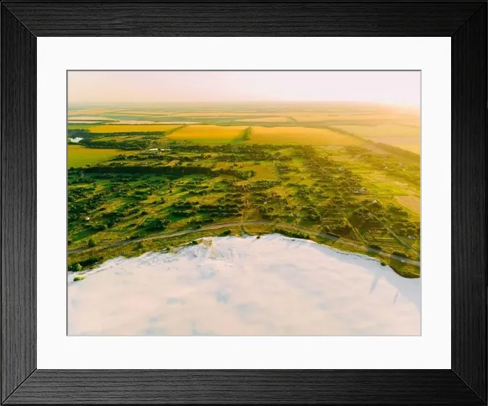 Framed Print : Border of desertification territory and green meadow with river is a result human destructive activity in environment Framed Print : Border of desertification territory and green meadow with river is a result human destructive activity in environment
