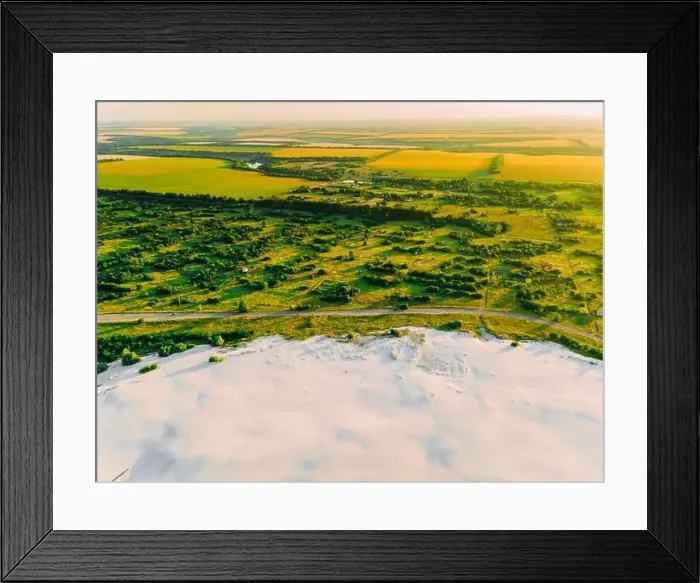 Framed Print : Border of desertification territory and green meadow with river is a result human destructive activity in environment Framed Print : Border of desertification territory and green meadow with river is a result human destructive activity in environment