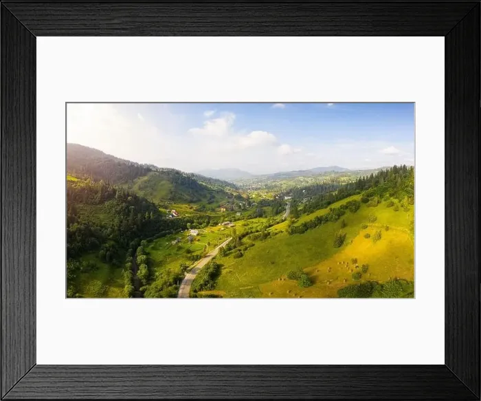 Framed Print : Scenic panoramic landscape. Aerial drone view of picturesque urban-type settlement in valley among green nature