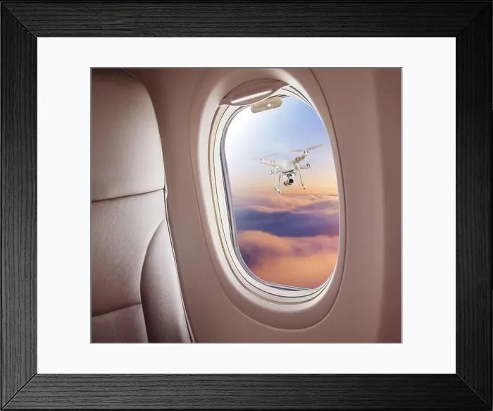 Framed Print : Airplane interior with window view of drone flying nearby. Concept of travel, air transportation and danger of collision Framed Print : Airplane interior with window view of drone flying nearby. Concept of travel, air transportation and danger of collision