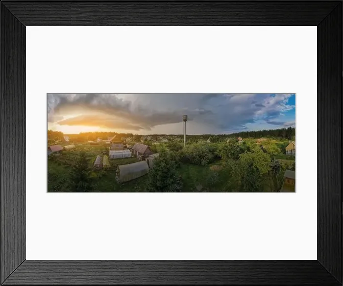 Framed Print : High View from the height of a flying drone, a small village with houses and cottages, green fields on a summer day Framed Print : High View from the height of a flying drone, a small village with houses and cottages, green fields on a summer day