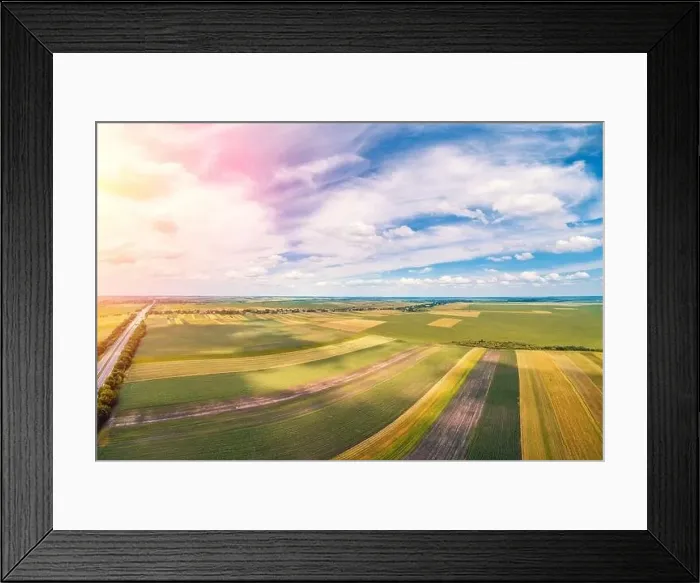 Framed Print : Rural landscape with a beautiful sky. Aerial view. View of colorful arable fields in summer Framed Print : Rural landscape with a beautiful sky. Aerial view. View of colorful arable fields in summer