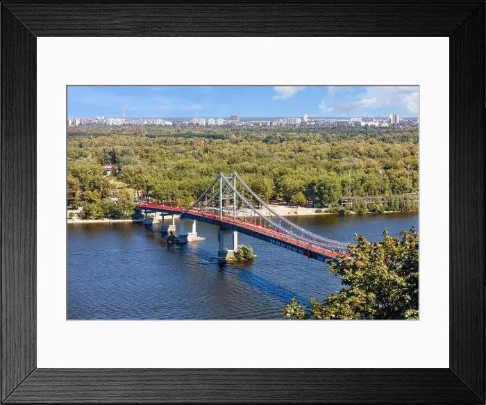 Framed Print : Pedestrian bridge over the Dnipro river to the beach of Trukhaniv island at noon in Kyiv, aerial view, Ukraine Framed Print : Pedestrian bridge over the Dnipro river to the beach of Trukhaniv island at noon in Kyiv, aerial view, Ukraine